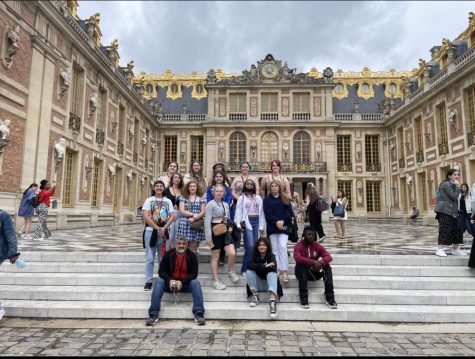 Milton High School students pose in front of the Palace of Versailles on a trip in 2022.
