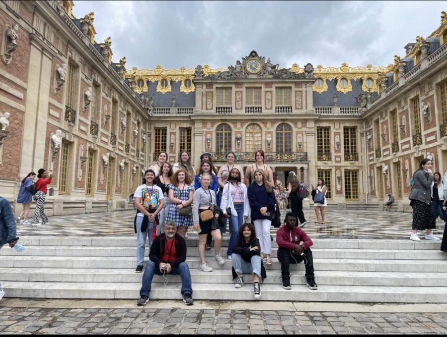Milton High School students pose in front of the Palace of Versailles on a trip in 2022.