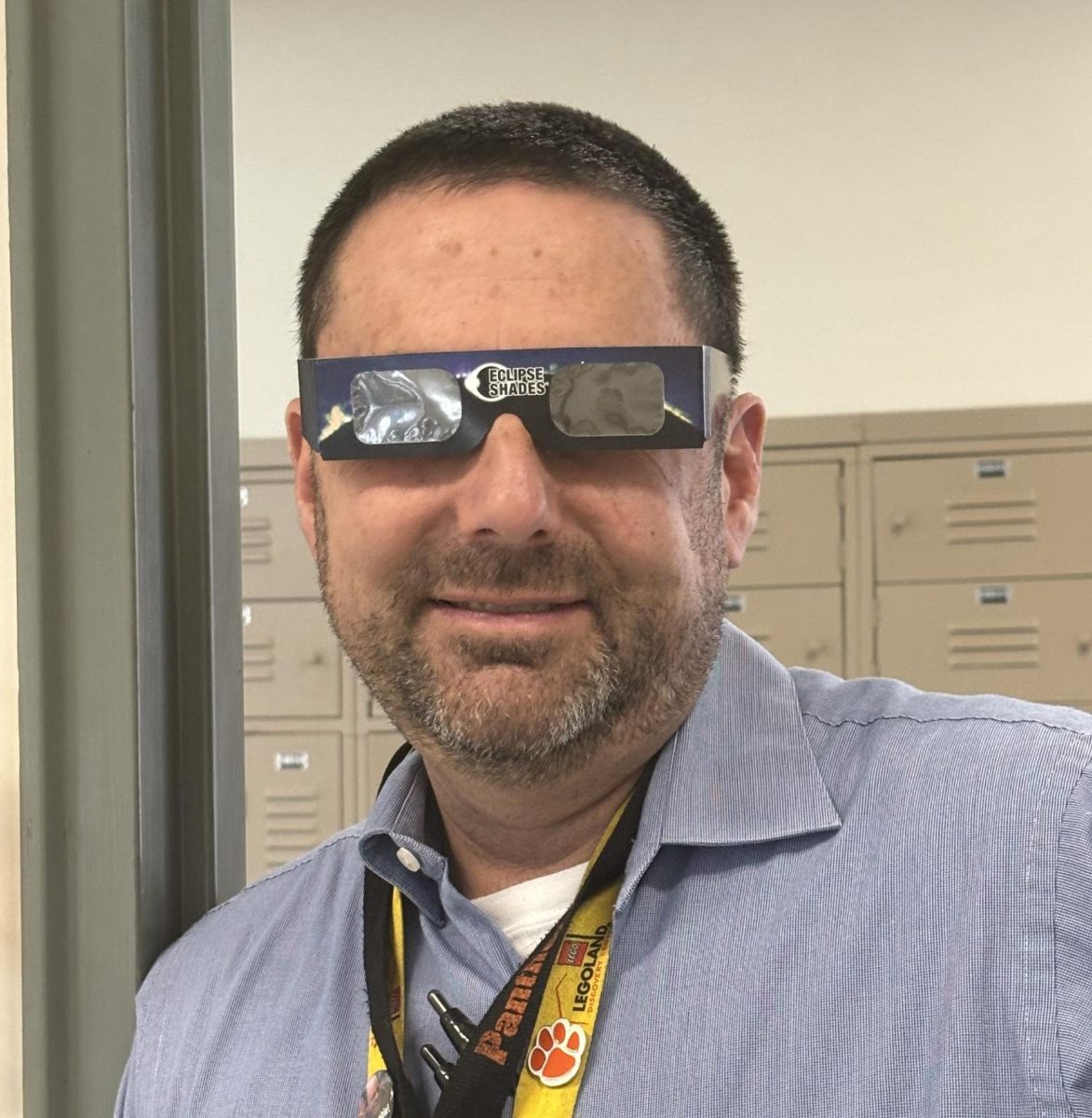 BCIT Instructor Mr. Seth Reitz wears the protective eclipse glasses.
