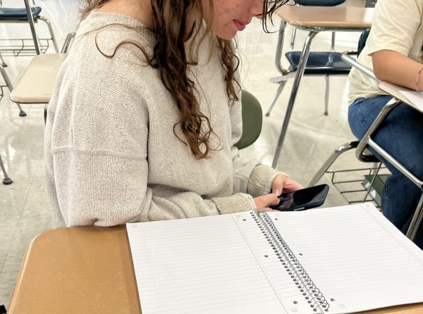 student sneaking phone in class
