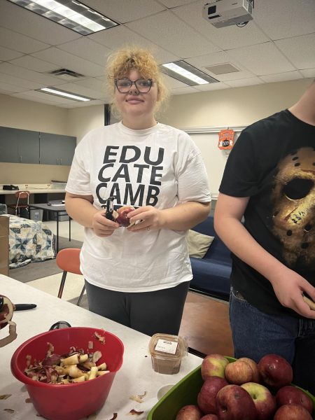 Former student Tatiana Roberts prepares treats for the snack cart.